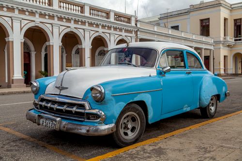Free A vintage 1950s American car parked on the streets of Santa Clara, Cuba, showcasing historic architecture. Stock Photo