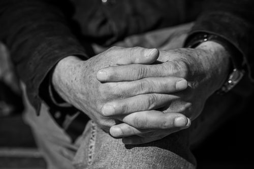 Free Black and white close-up of elderly hands clasped together, showcasing texture and detail. Stock Photo