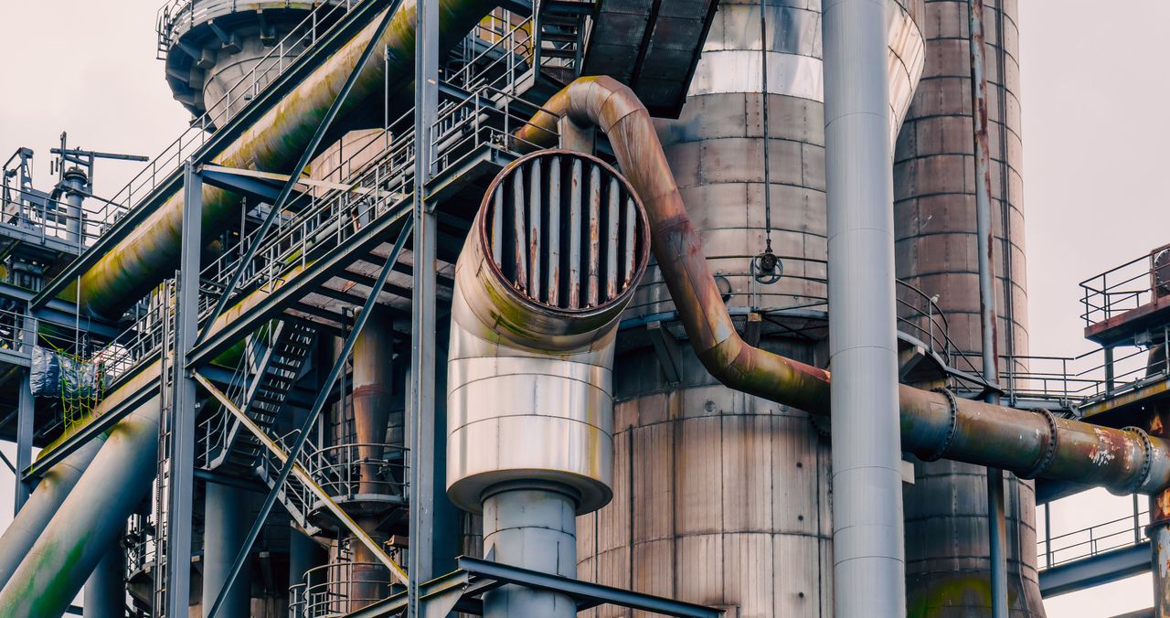 close up view of rusted industrial plant pipes and structures showcasi