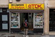 Shopfront of a vintage electronics store in Madrid, offering cassettes and other retro gadgets.
