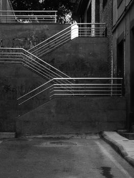Monochrome image of an empty urban staircase showcasing modern architecture.