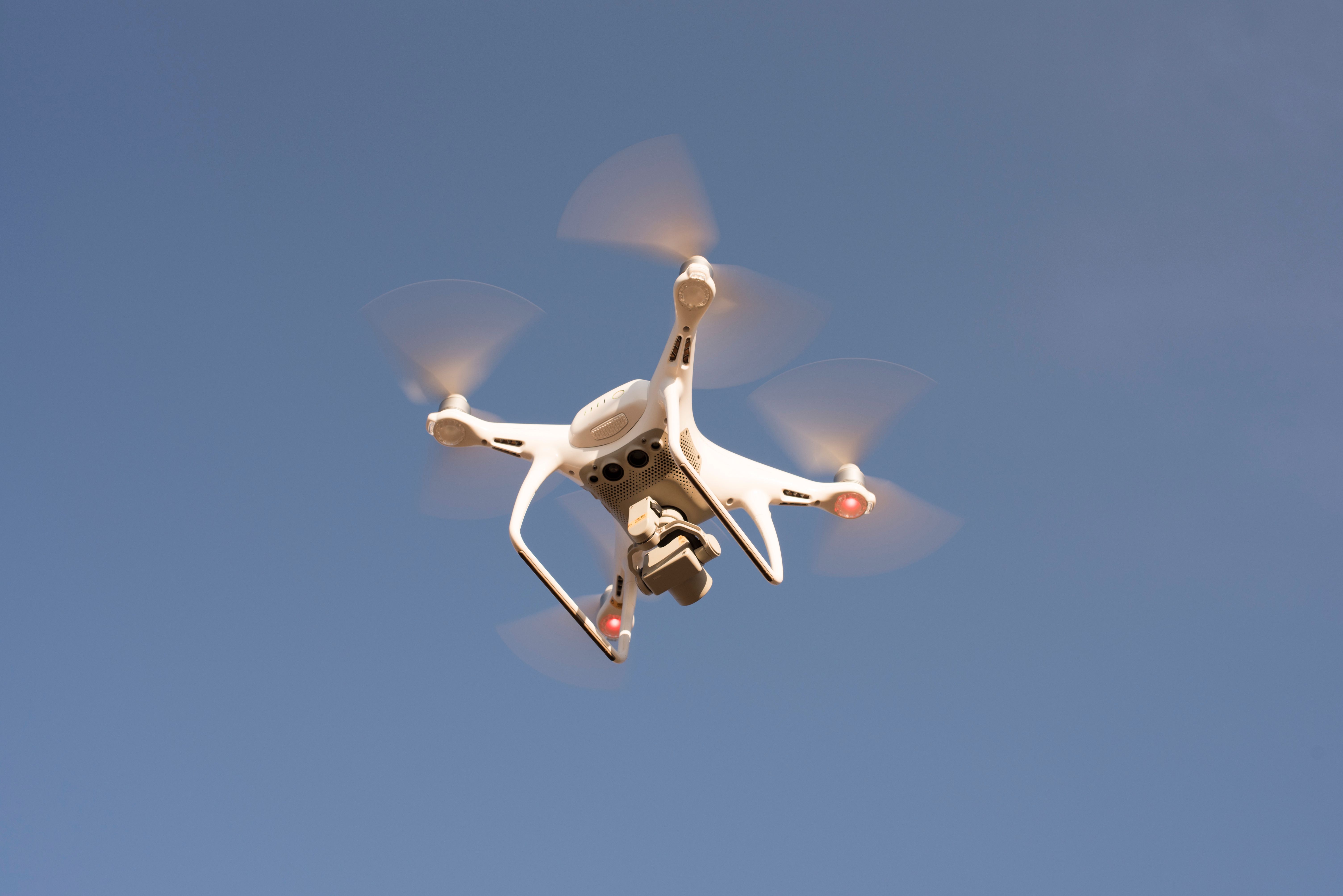 low-angle-shot-of-drone-flying-in-the-sky-free-stock-photo