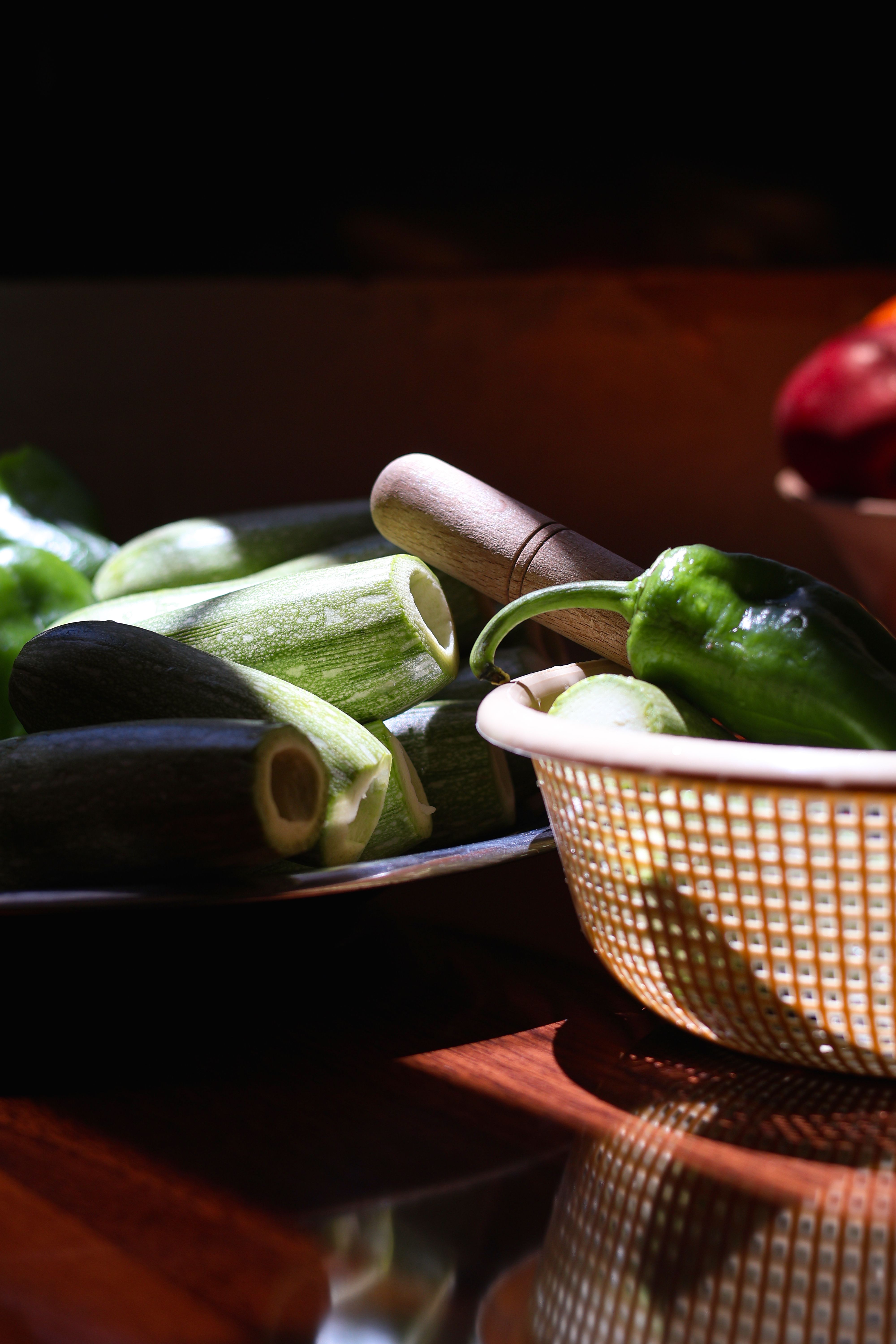 Vibrant zucchini and peppers in a rustic kitchen setting, highlighting home cooking and vegetable preparation.