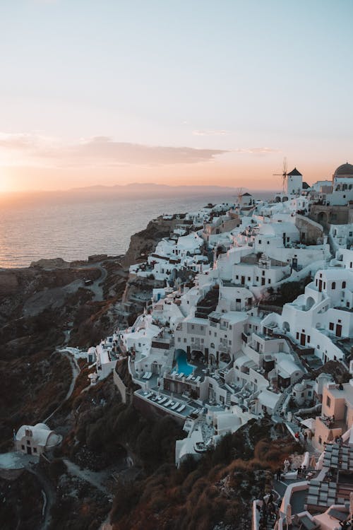 White Concrete Buildings Near Body of Water
