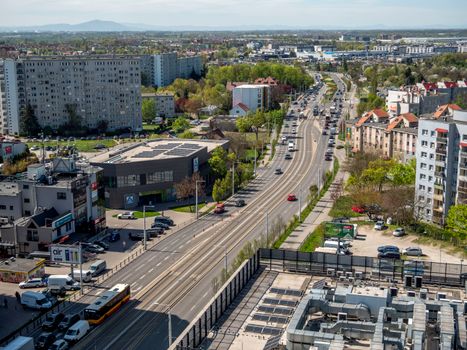 Aerial shot of Wrocław cityscape with bustling roads and residential buildings in spring.