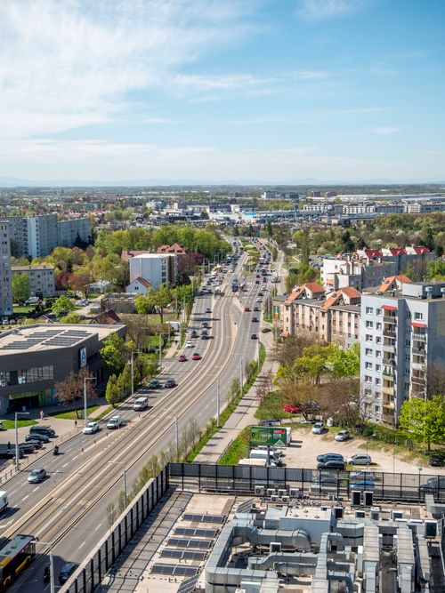 Free Aerial shot of Wrocław, Poland, showcasing urban landscape and greenery beneath a clear spring sky. Stock Photo