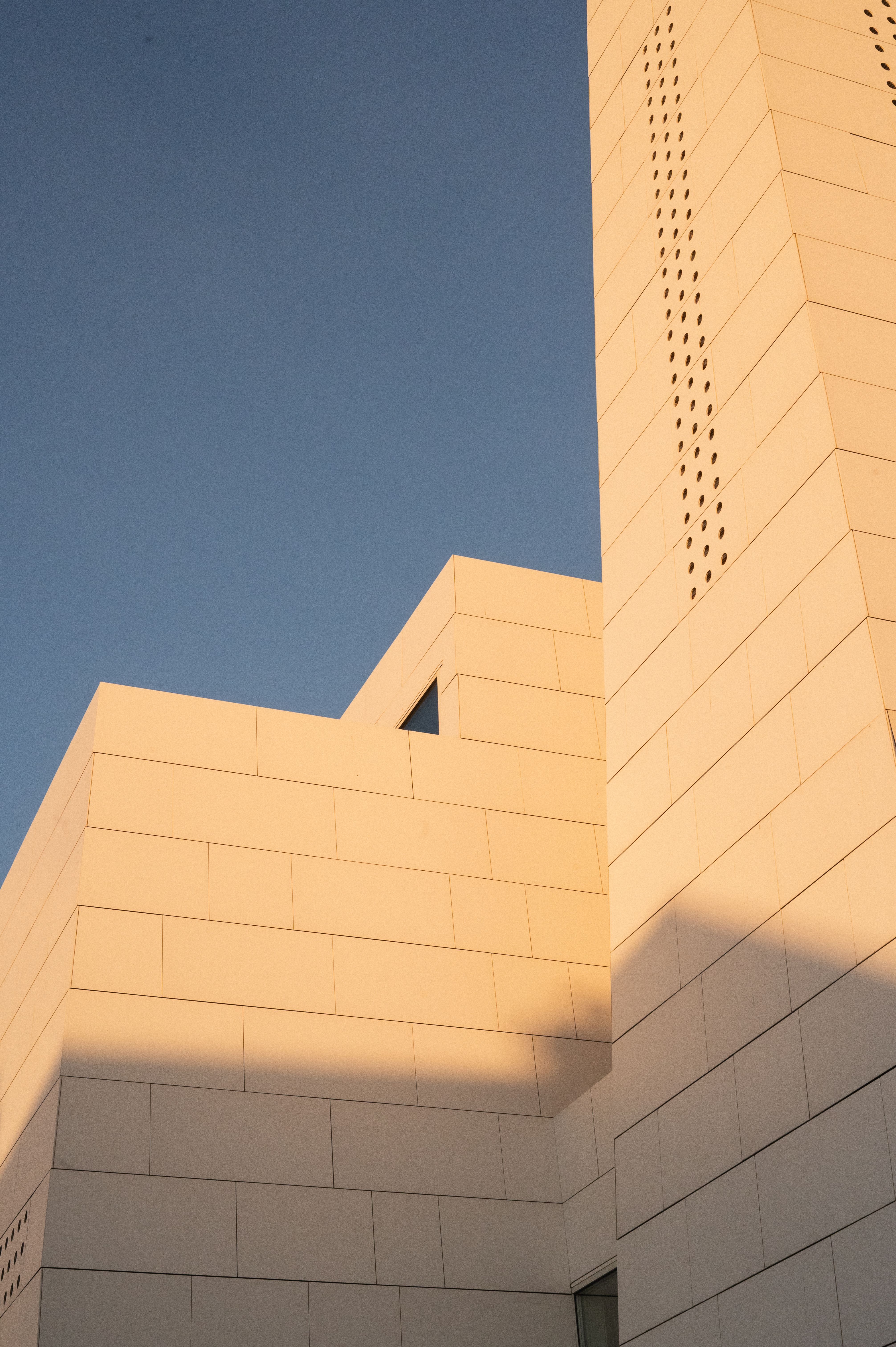 Sleek modern church building in Norway with clean architectural lines in soft sunlight