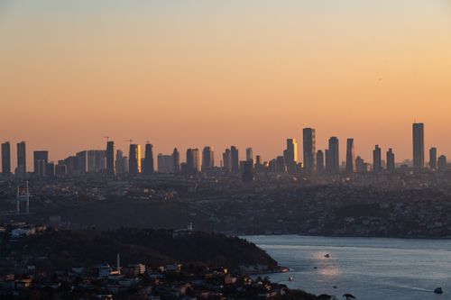 Free Dramatic sunset skyline view of Istanbul with silhouette of skyscrapers and Bosphorus Strait. Stock Photo