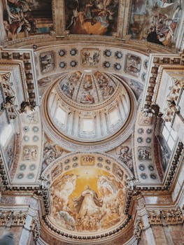 Stunning view of the ornate dome inside Bologna Cathedral, featuring intricate frescoes and architectural details.