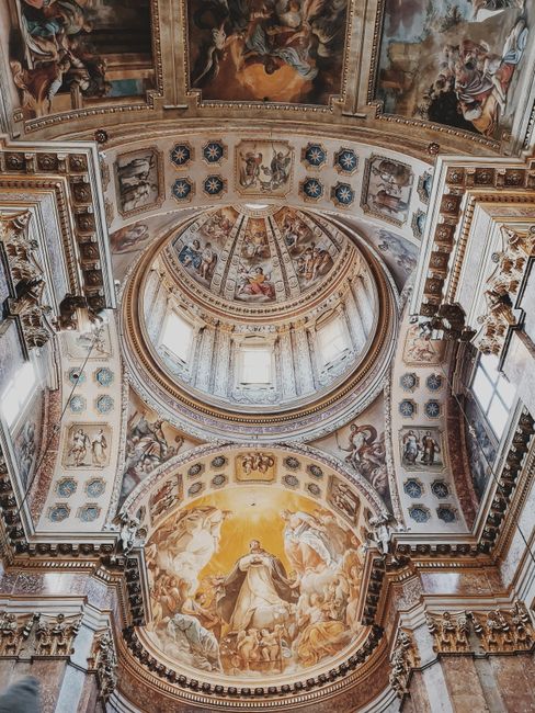Stunning view of the ornate dome inside Bologna Cathedral, featuring intricate frescoes and architectural details.
