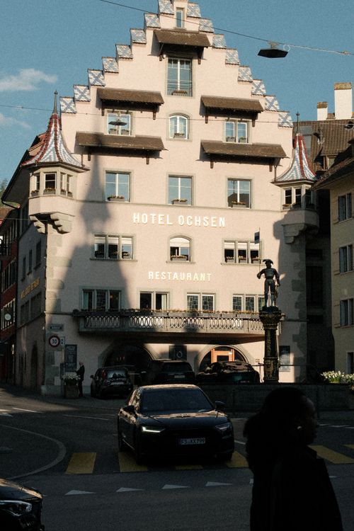 Free Sunlit facade of the historic Hotel Ochsen in Zug, showcasing its traditional architecture. Stock Photo