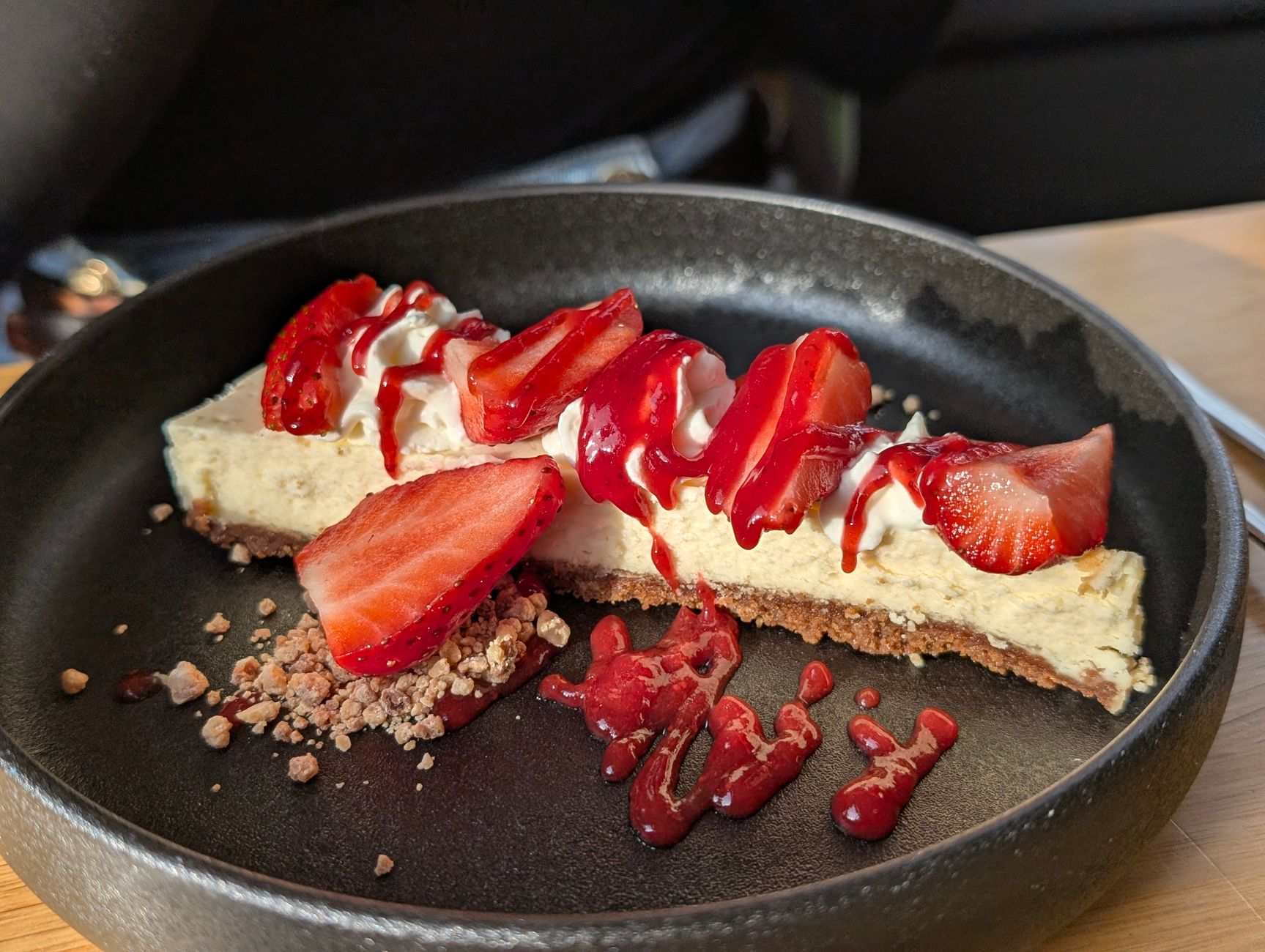 Close-up of golden crumble topping on strawberry cheesecake bars
