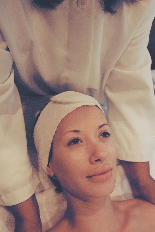 Free A woman enjoys a calming facial treatment at a spa, promoting relaxation and wellness. Stock Photo