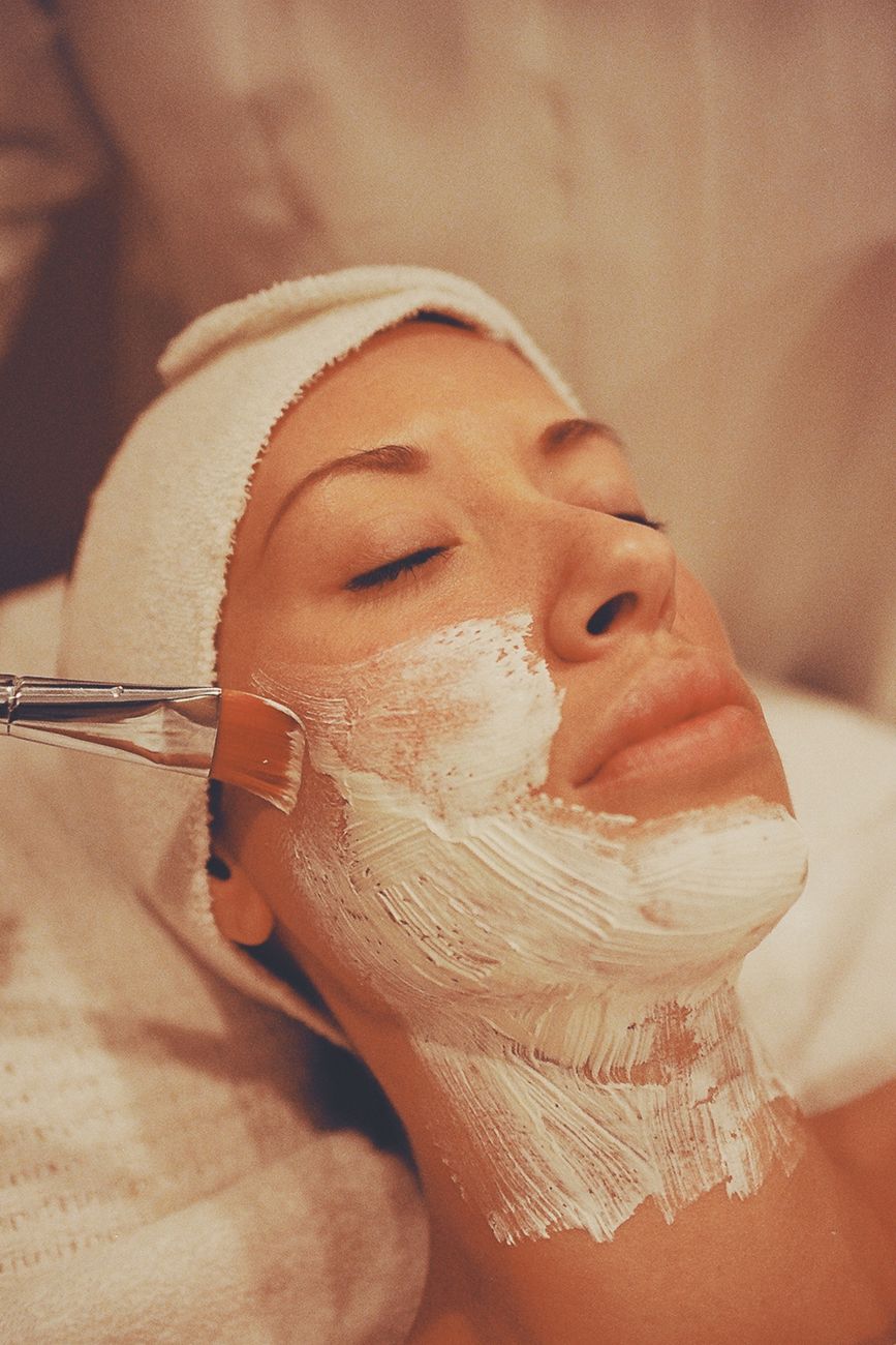 A woman enjoys a soothing facial mask application during a relaxing spa session.