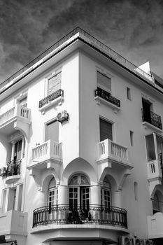 Elegant Mediterranean style building captured in dramatic black and white photograph.
