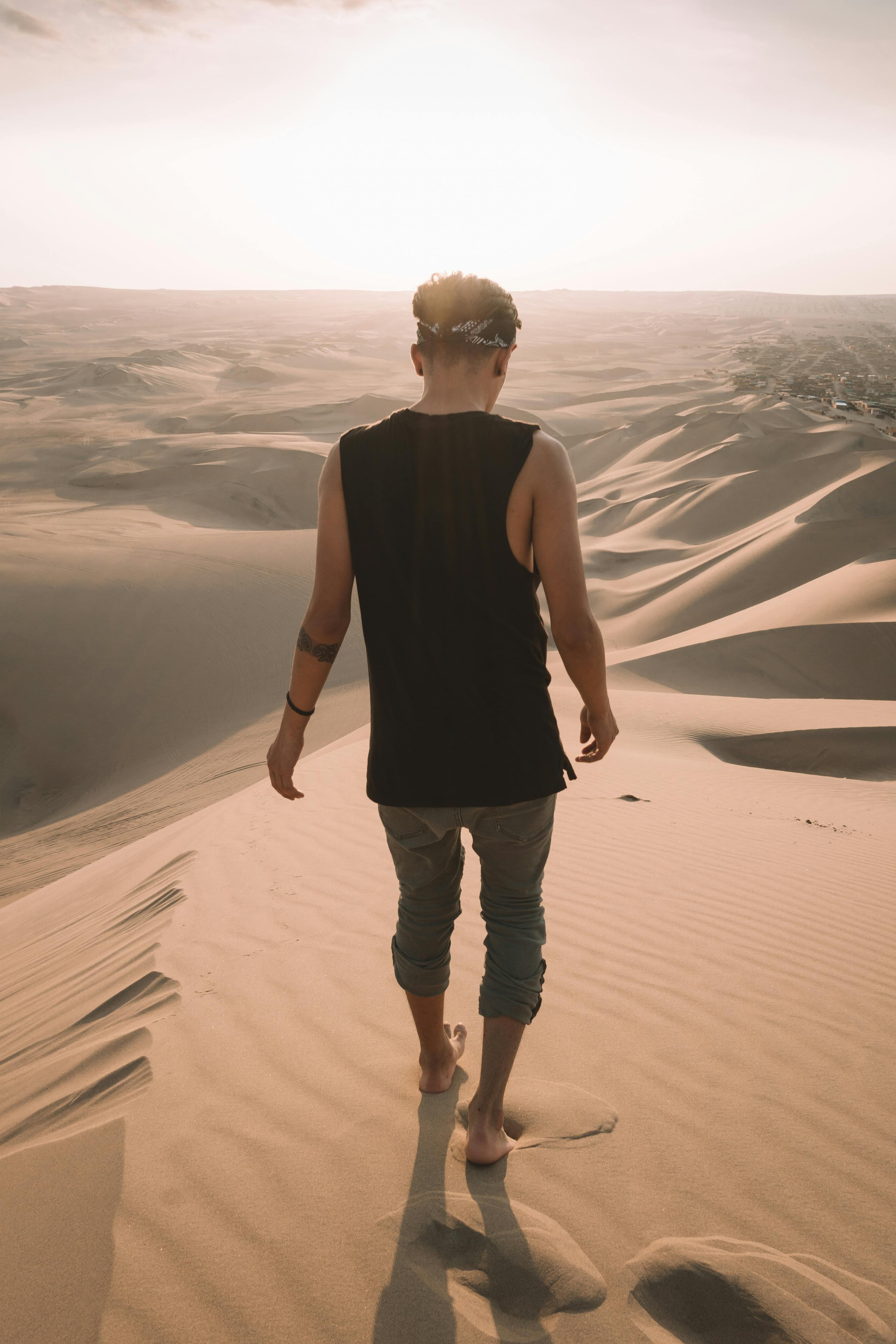 Man walking on the desert. | Photo: Pexels