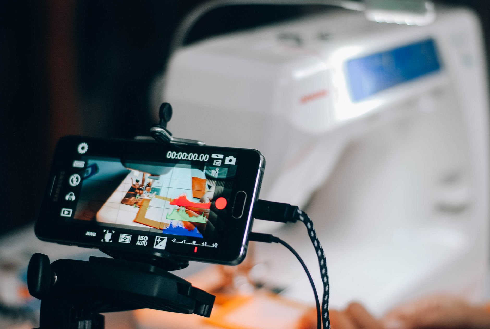 Smartphone capturing sewing machine process, perfect for DIY and crafting content.