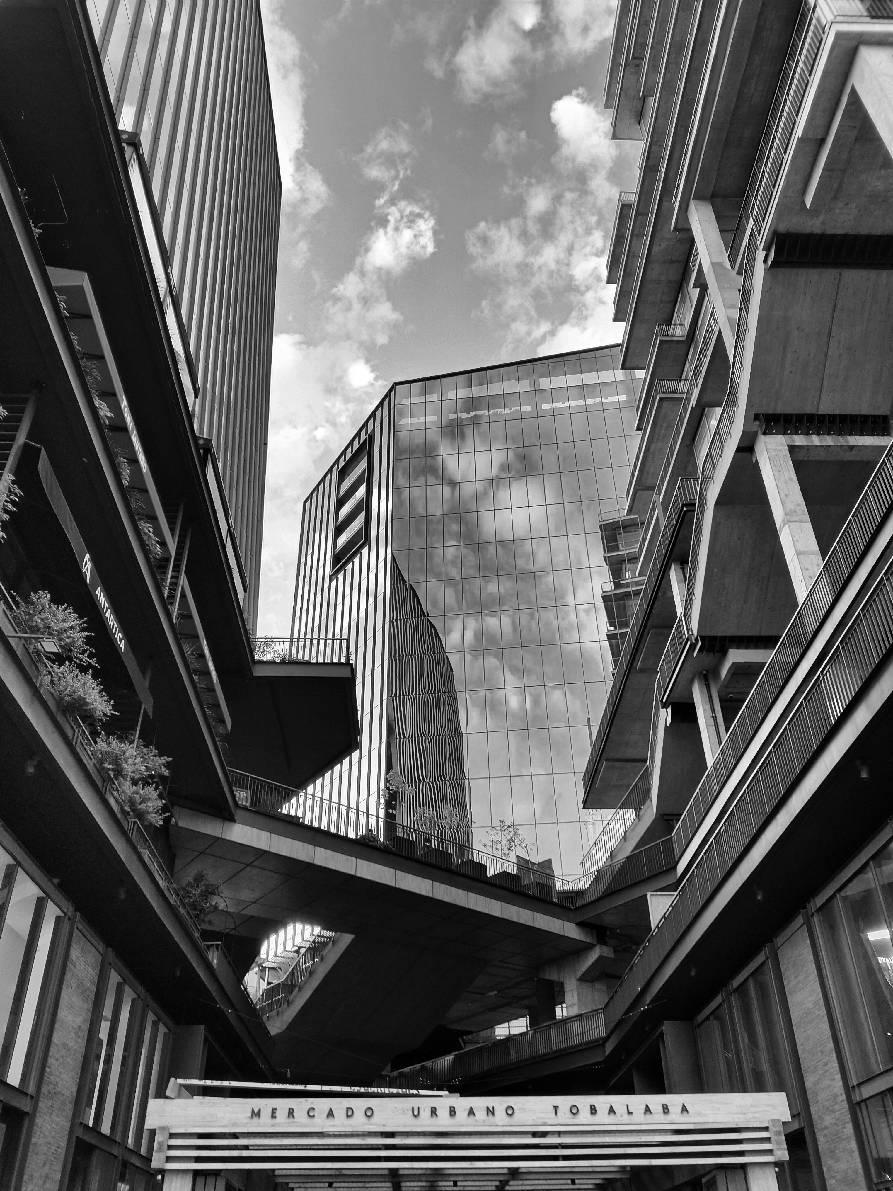 Black and white view of modern buildings in Las Condes, Chile, featuring Mercado Urbano Tobalaba.