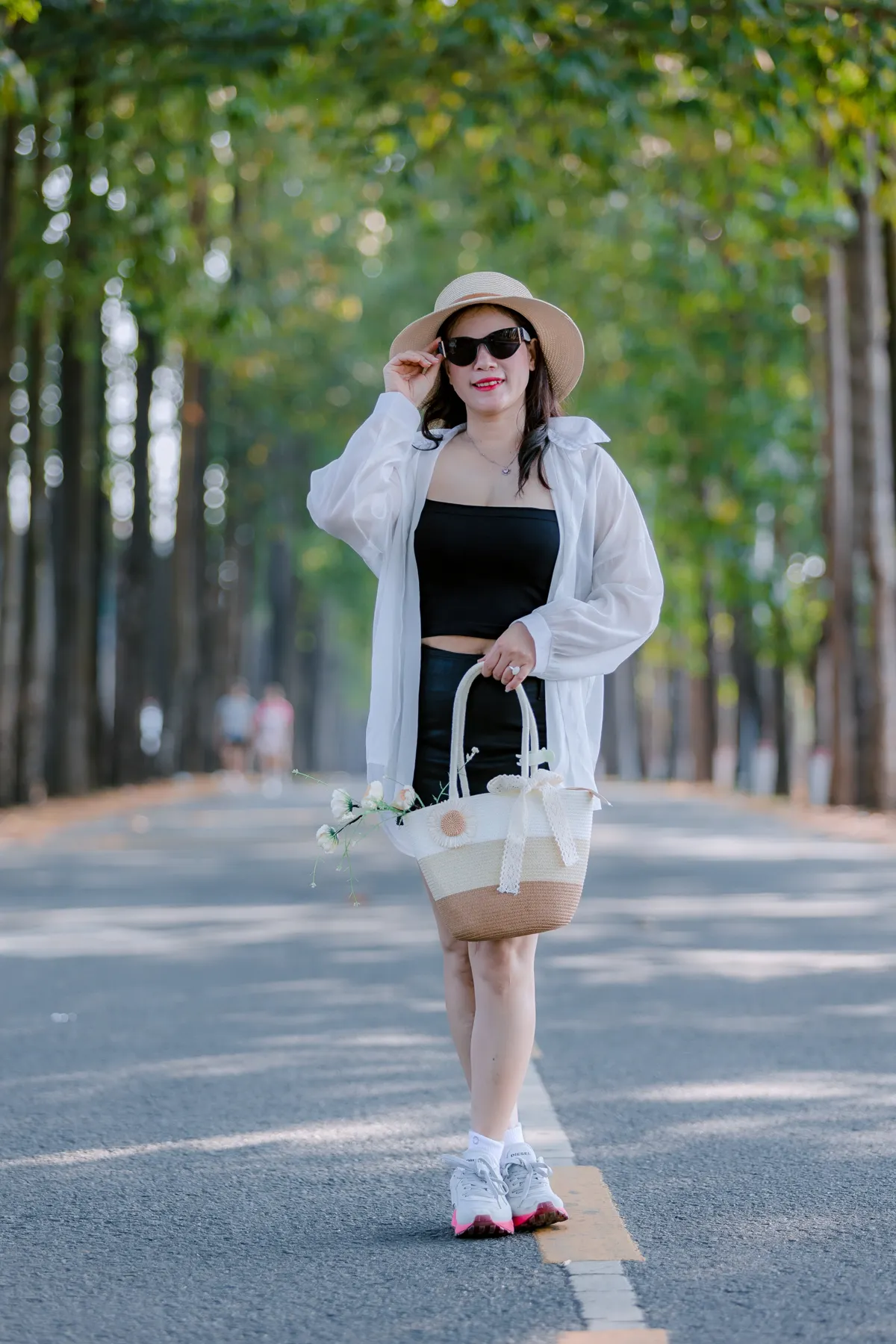 Woman walking on sunny park path