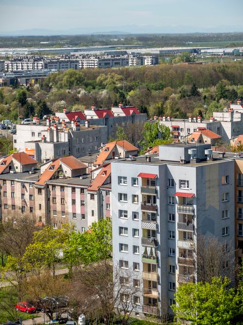Free Aerial view of residential buildings in Wrocław, Poland, surrounded by lush greenery. Stock Photo