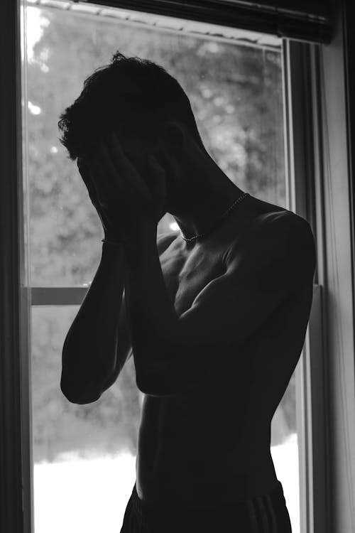 Monochrome Photo of Man Showing Sadness
