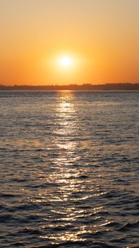Capture of the Bosphorus in Istanbul during a vibrant sunset with golden reflections in the water.