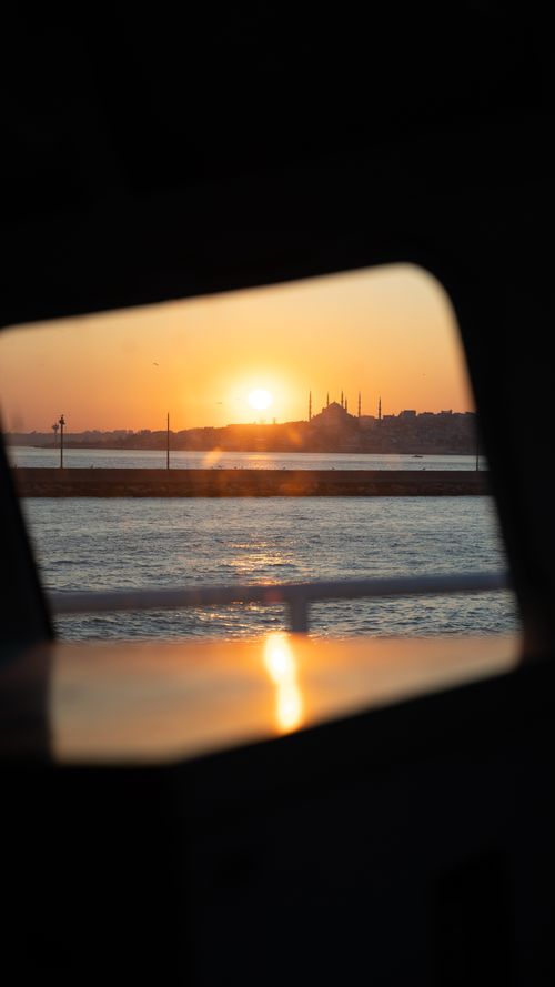 Free Captivating sunset over Istanbul's skyline, featuring silhouettes and vibrant hues reflected on water. Stock Photo