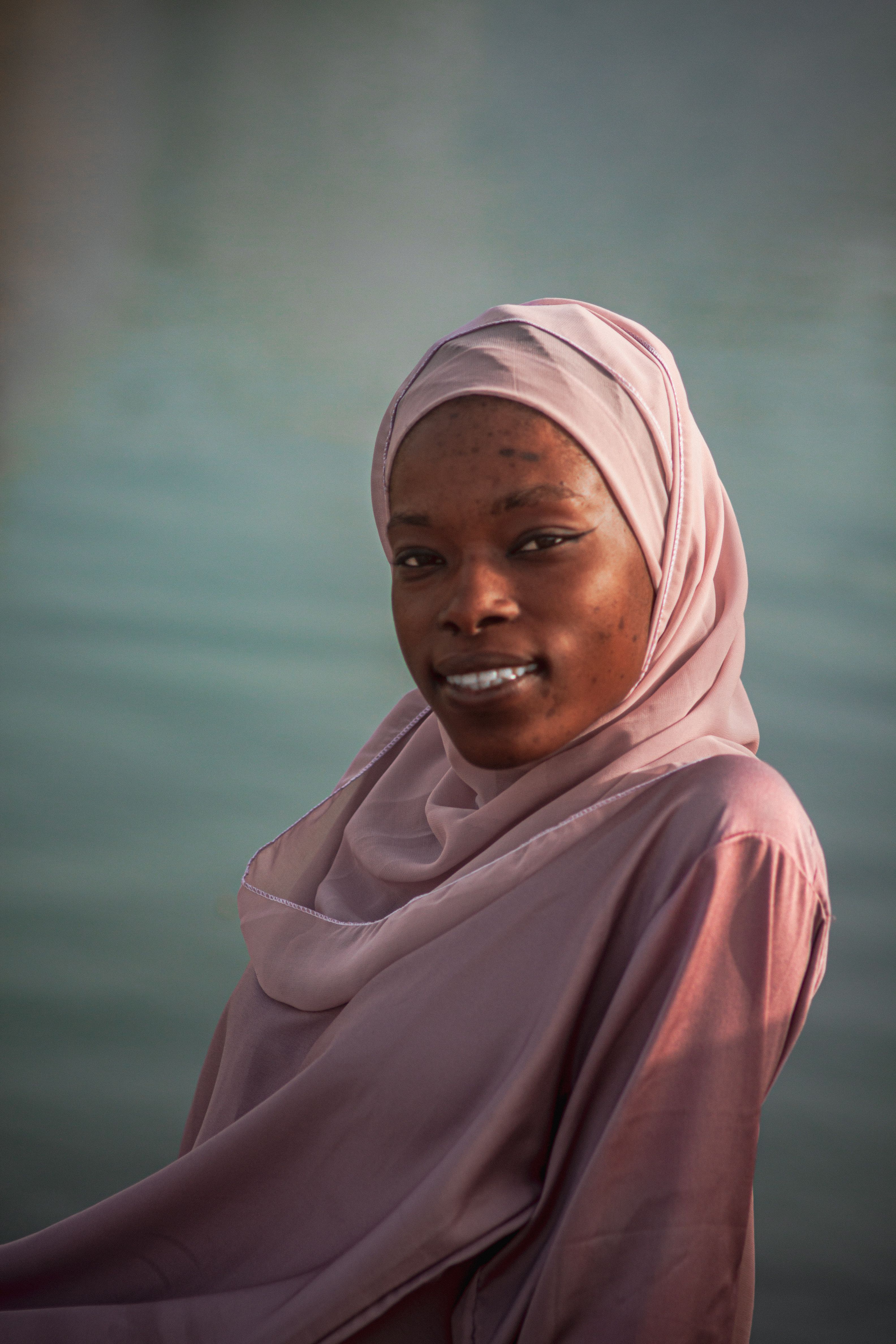 Portrait of Woman in Pink Hijab by Water · Free Stock Photo