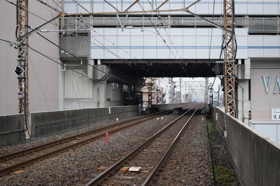埼玉県にある近代的な橋の下を通る鉄道線路の様子。都市交通インフラを象徴する光景である。