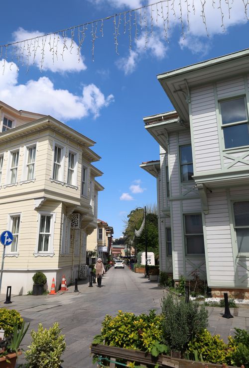 Free A picturesque street with historic architecture under a bright blue sky. Stock Photo