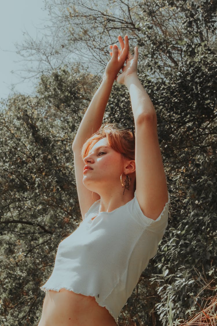 Woman In White Crew Neck T-shirt Raising Her Hands