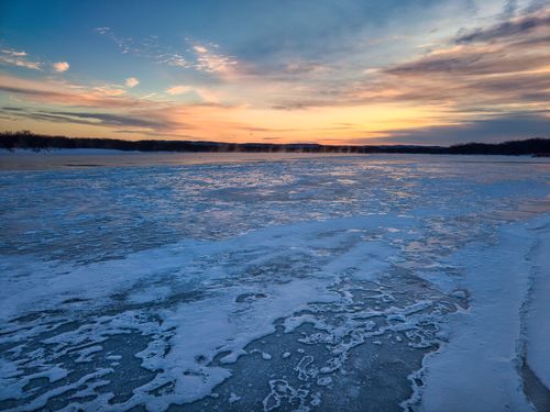 Free Beautiful sunset over icy lake in Reads Landing, Minnesota during winter. Stock Photo