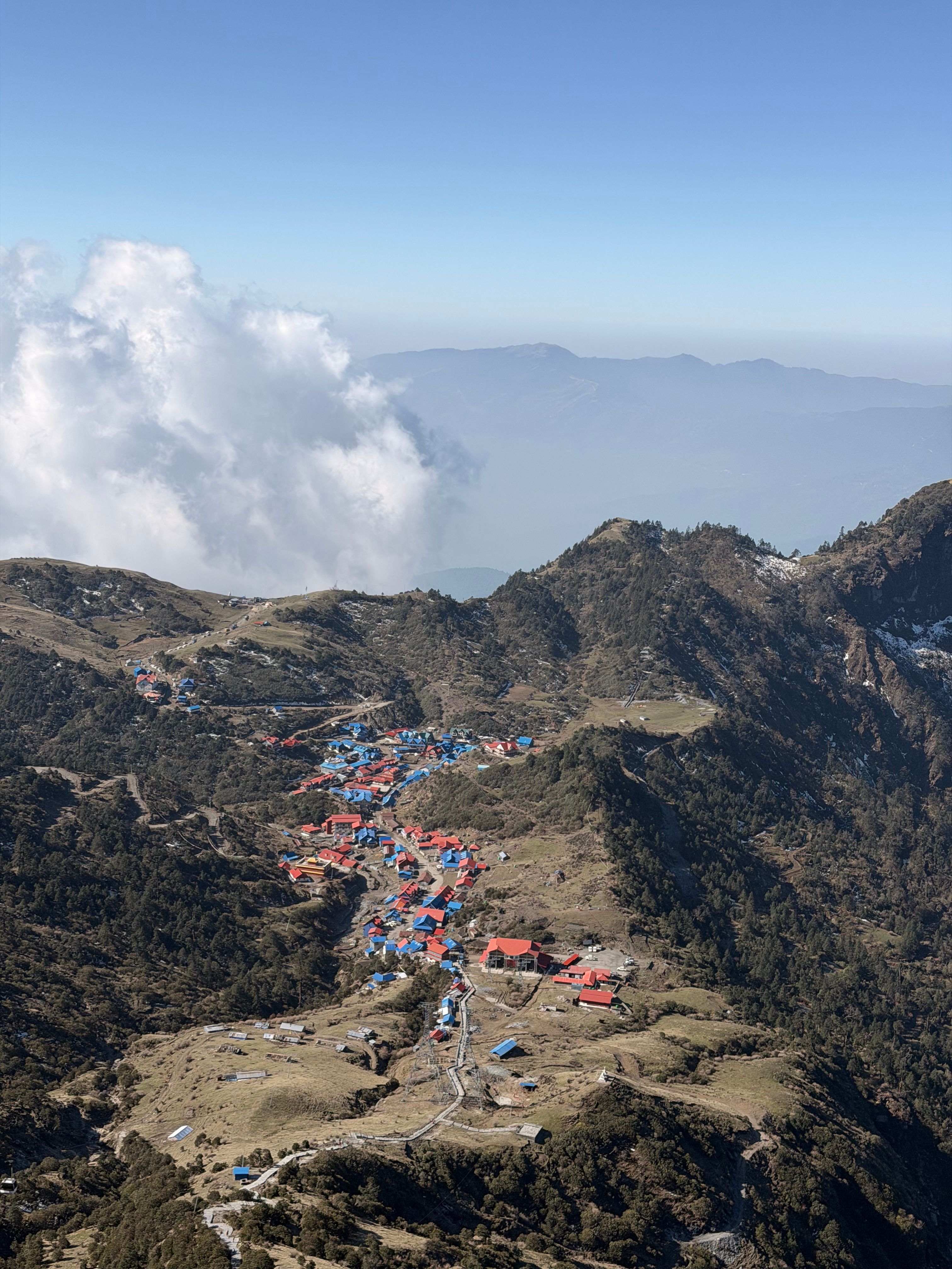 A stunning aerial view of a vibrant mountain village surrounded by lush landscapes.