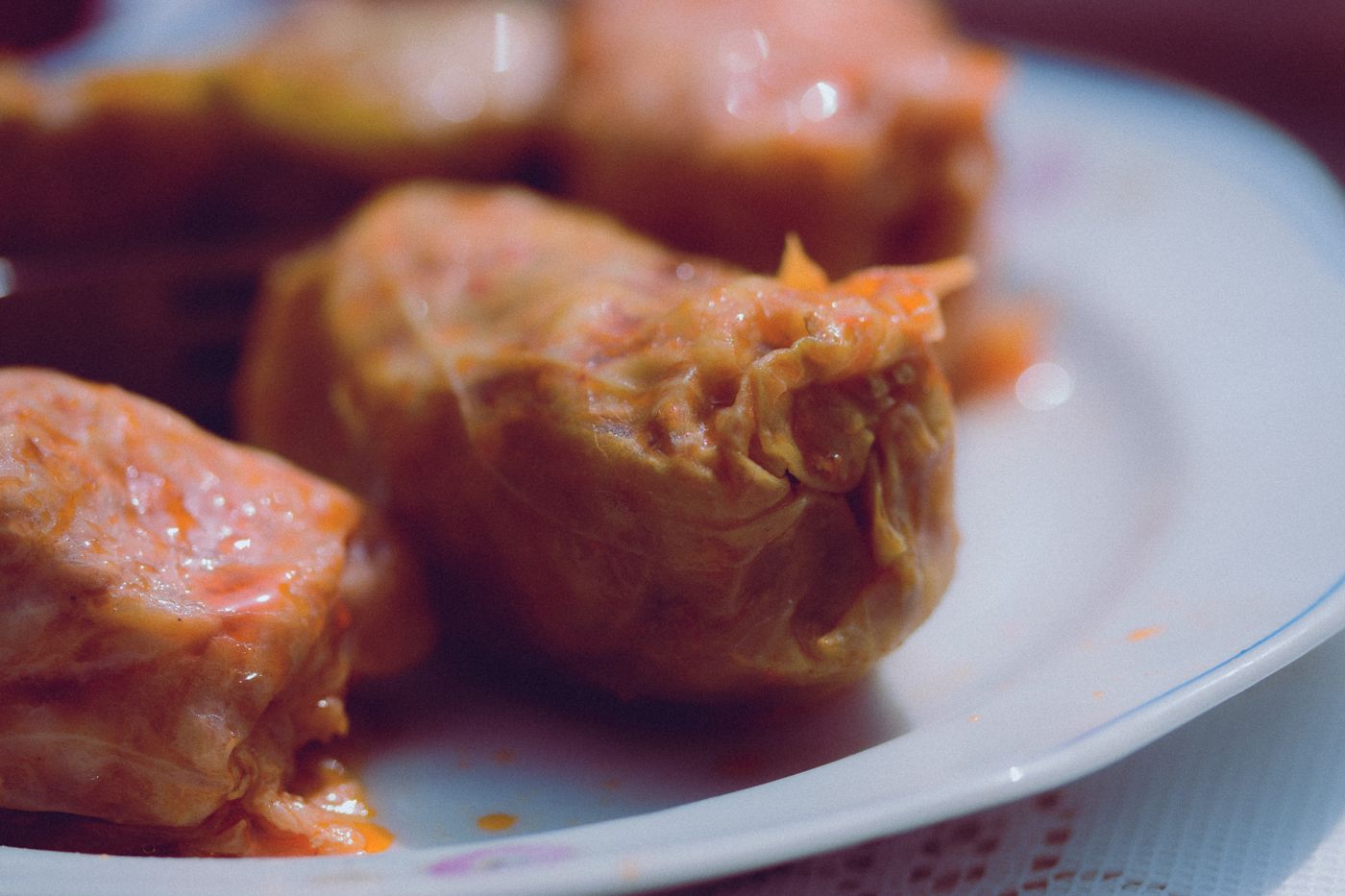 Delicious homemade stuffed cabbage rolls served on a white plate.