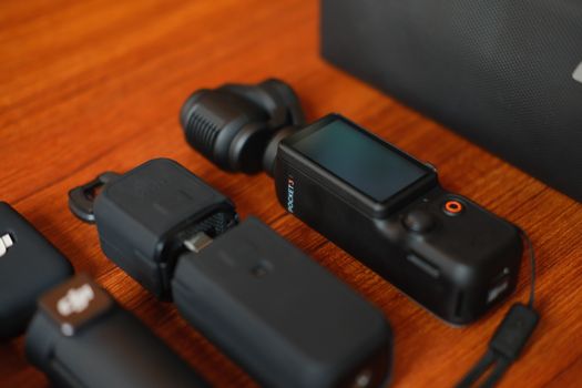 Compact camera gear and accessories neatly arranged on a wooden surface, ideal for travel and filming.