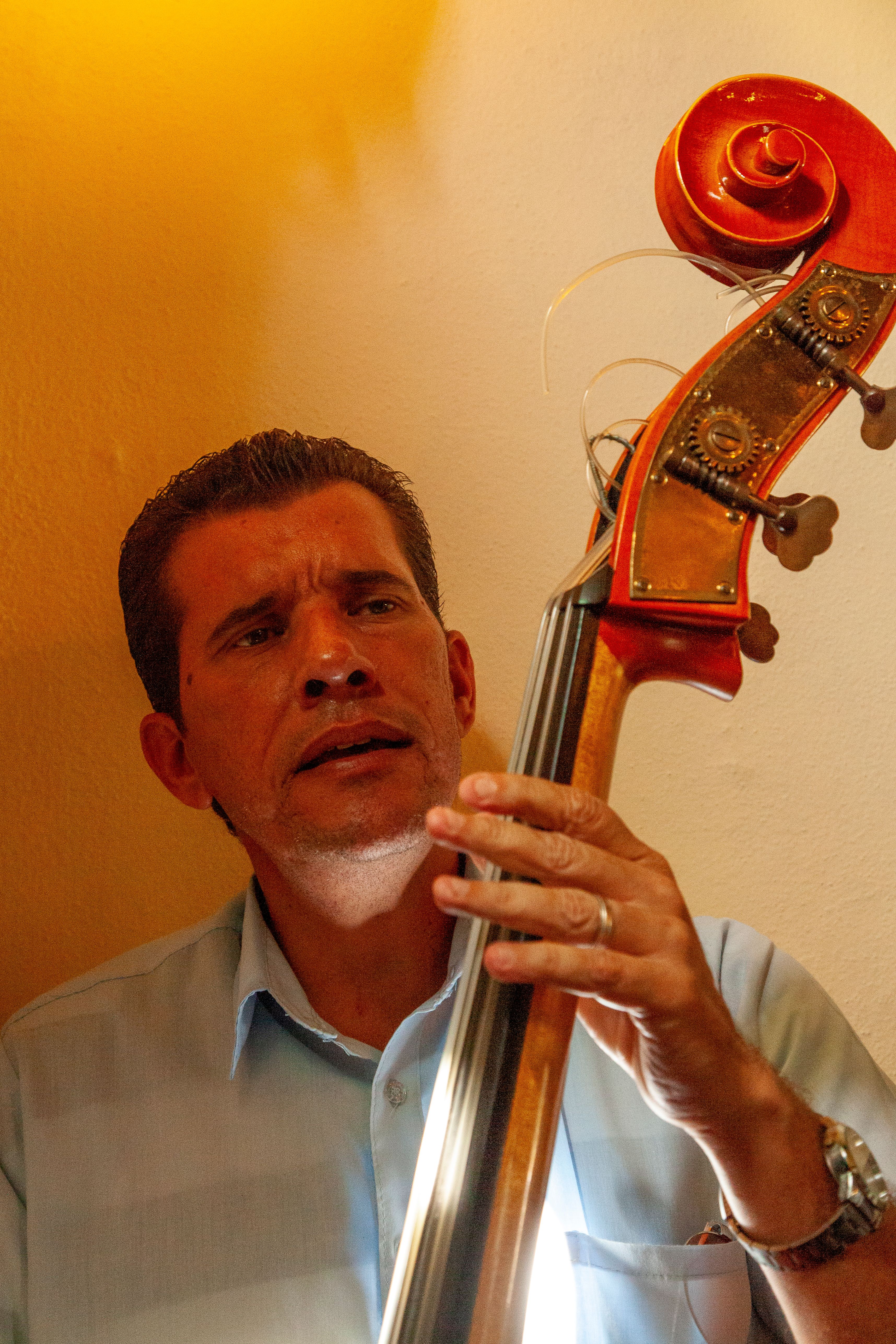 A musician immersed in playing the upright bass with emotion in Camagüey, Cuba.