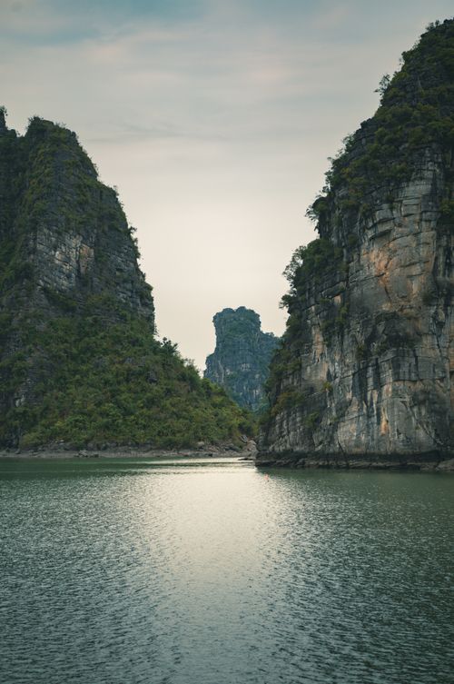 Free Breathtaking limestone karsts rising from tranquil waters, captured in Vietnam. Stock Photo
