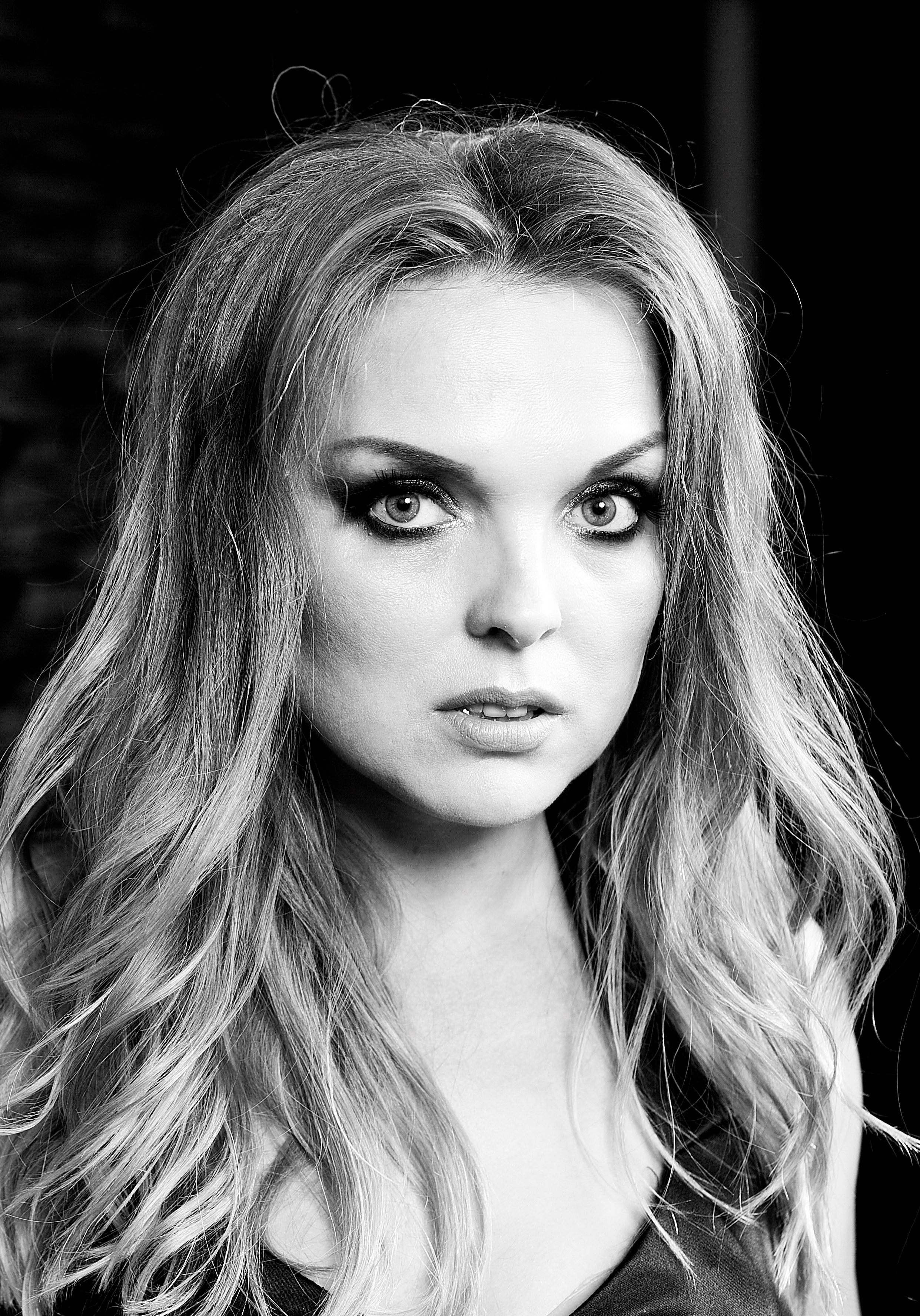 Dramatic black and white portrait capturing a woman's intense stare, showcasing beauty and emotion.