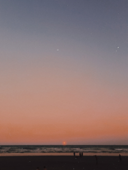 A breathtaking sunset at a Brazilian beach with a beautiful gradient sky.