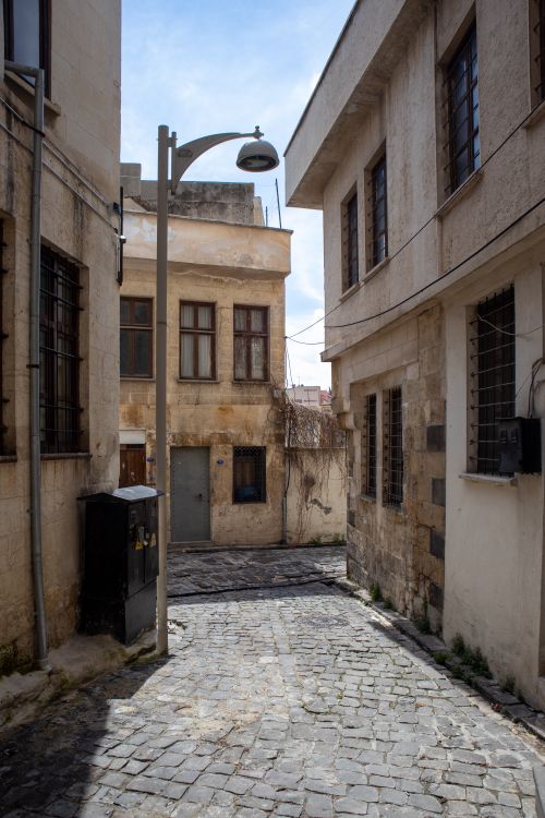 Free Charming cobblestone alley in Gaziantep, Türkiye showcasing historical architecture and tranquil ambiance. Stock Photo