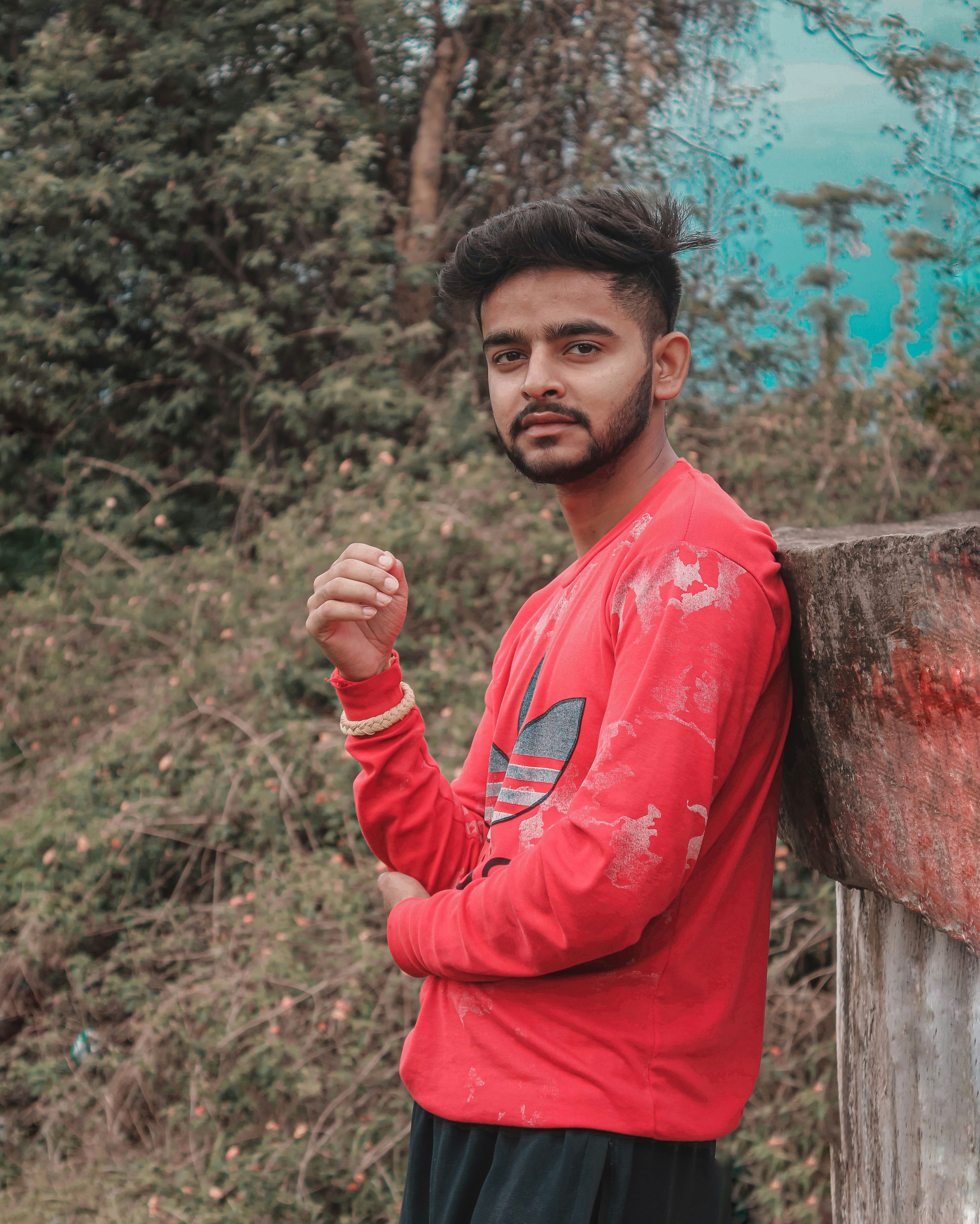 Portrait of a young man in casual wear amidst nature in Himachal Pradesh, India.