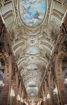 Stunning view of an ornate Baroque ceiling with intricate frescoes in a historical European building.