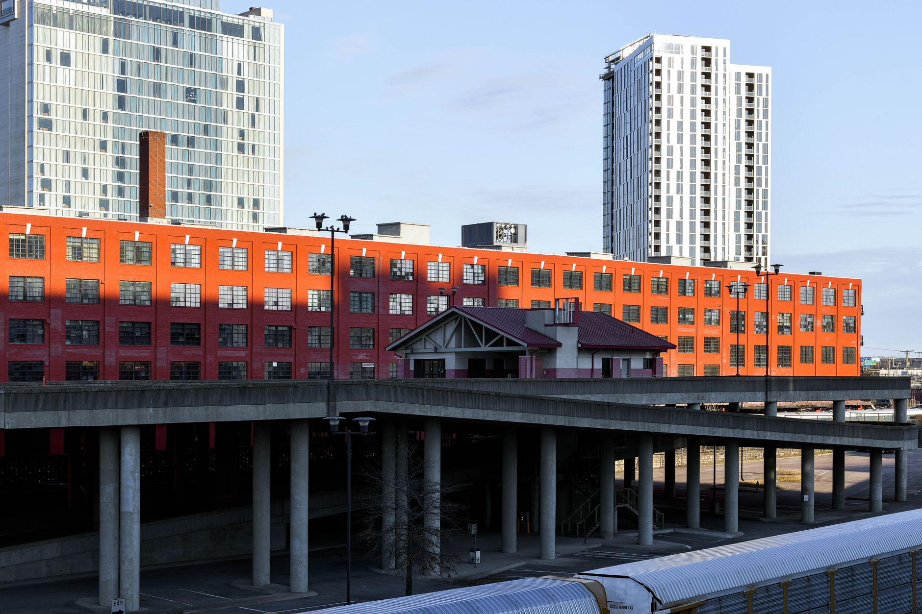 Cityscape featuring modern high-rises and distinct red building in Nashville.