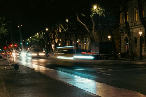Free Dynamic nighttime street scene in Budapest with blurred motion of cars and vibrant city lights. Stock Photo