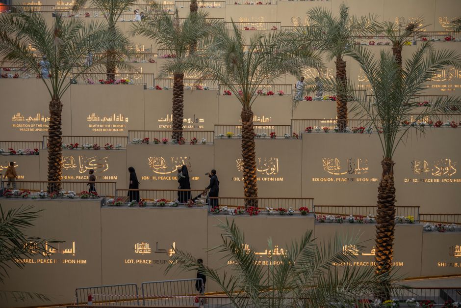 Traveler checking flight status on a mobile app at King Khalid International Airport, Riyadh, Saudi Arabia