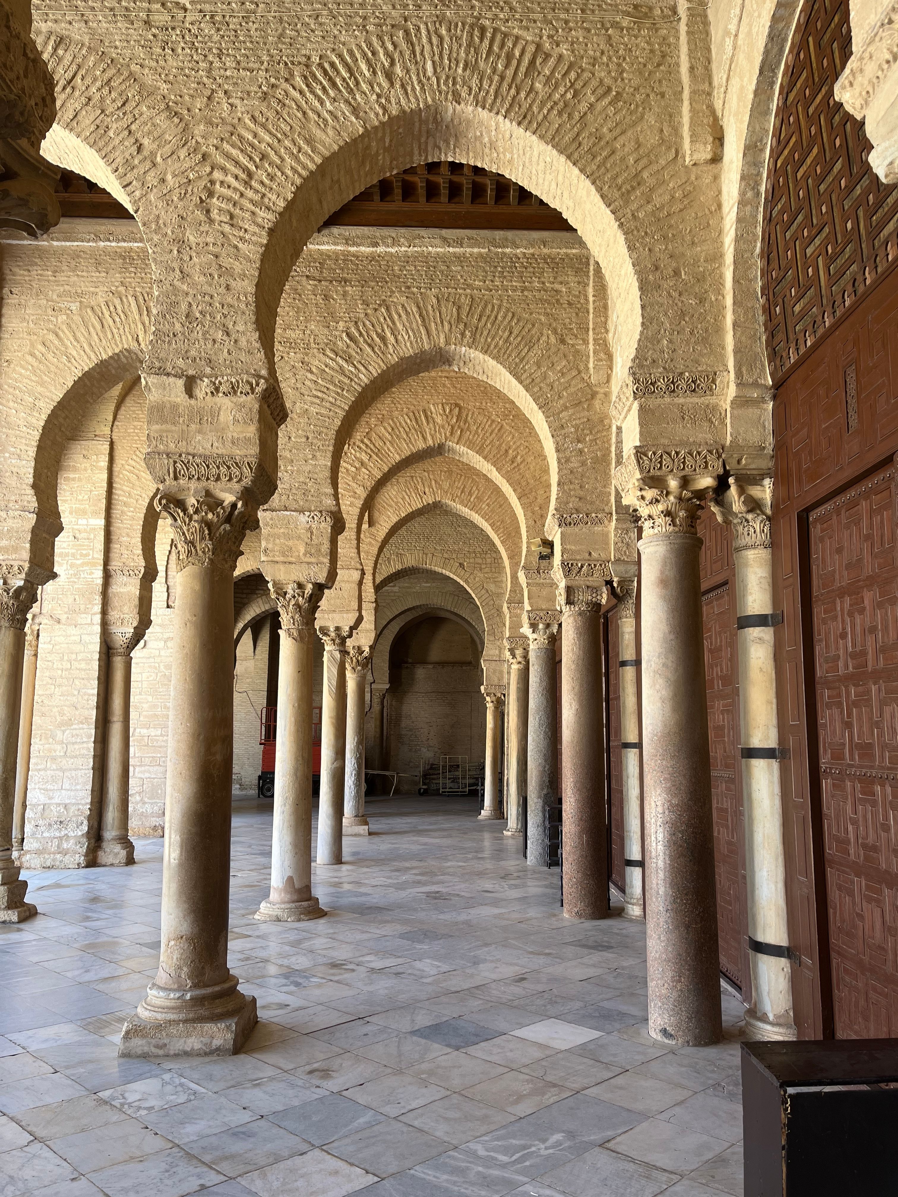 A beautifully arched hallway in the Great Mosque of Kairouan, showcasing timeless Islamic architecture.
