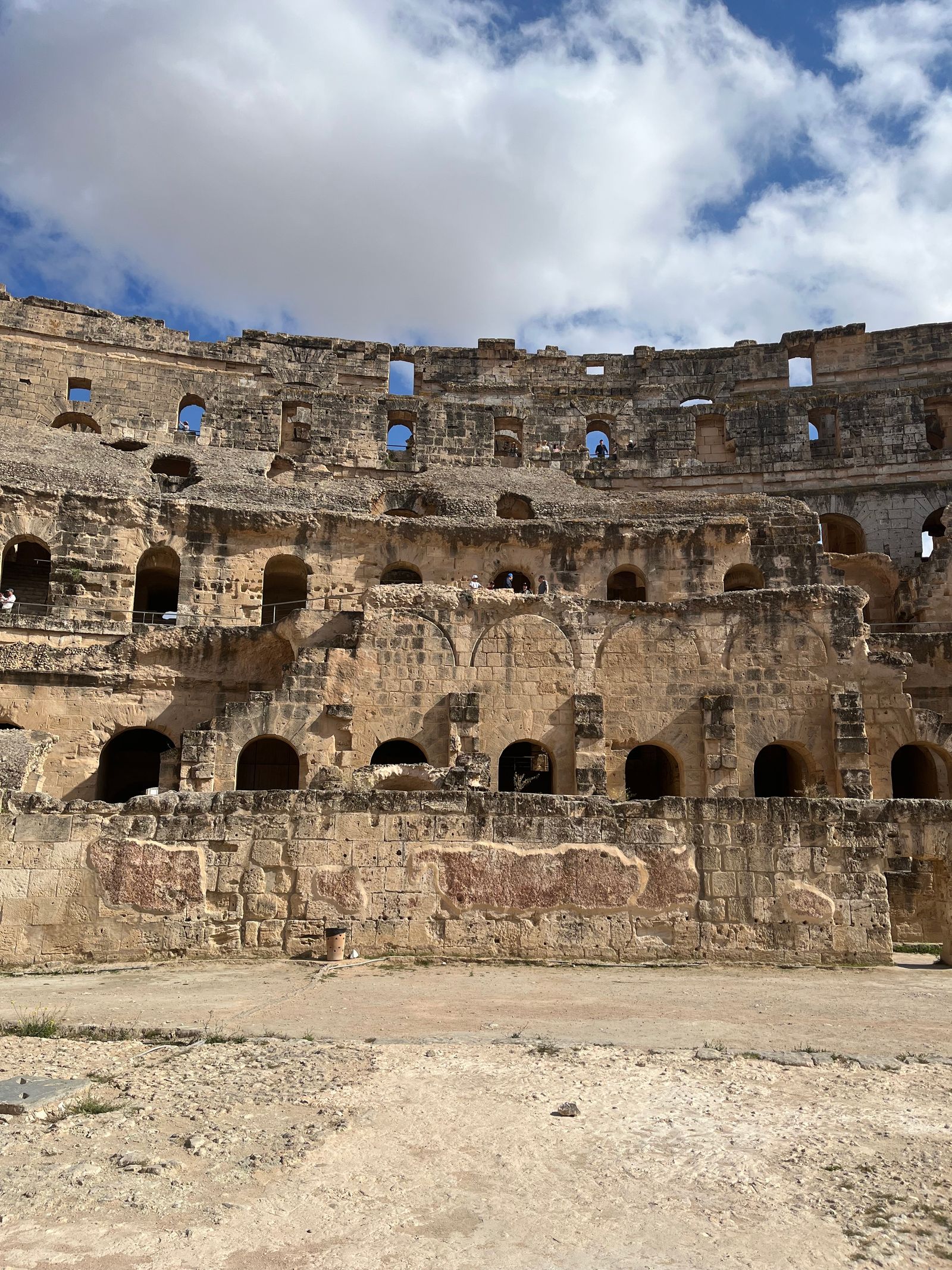 El Jem Amphitheatre in Tunisia, showcasing ancient Roman architecture under a clear sky.