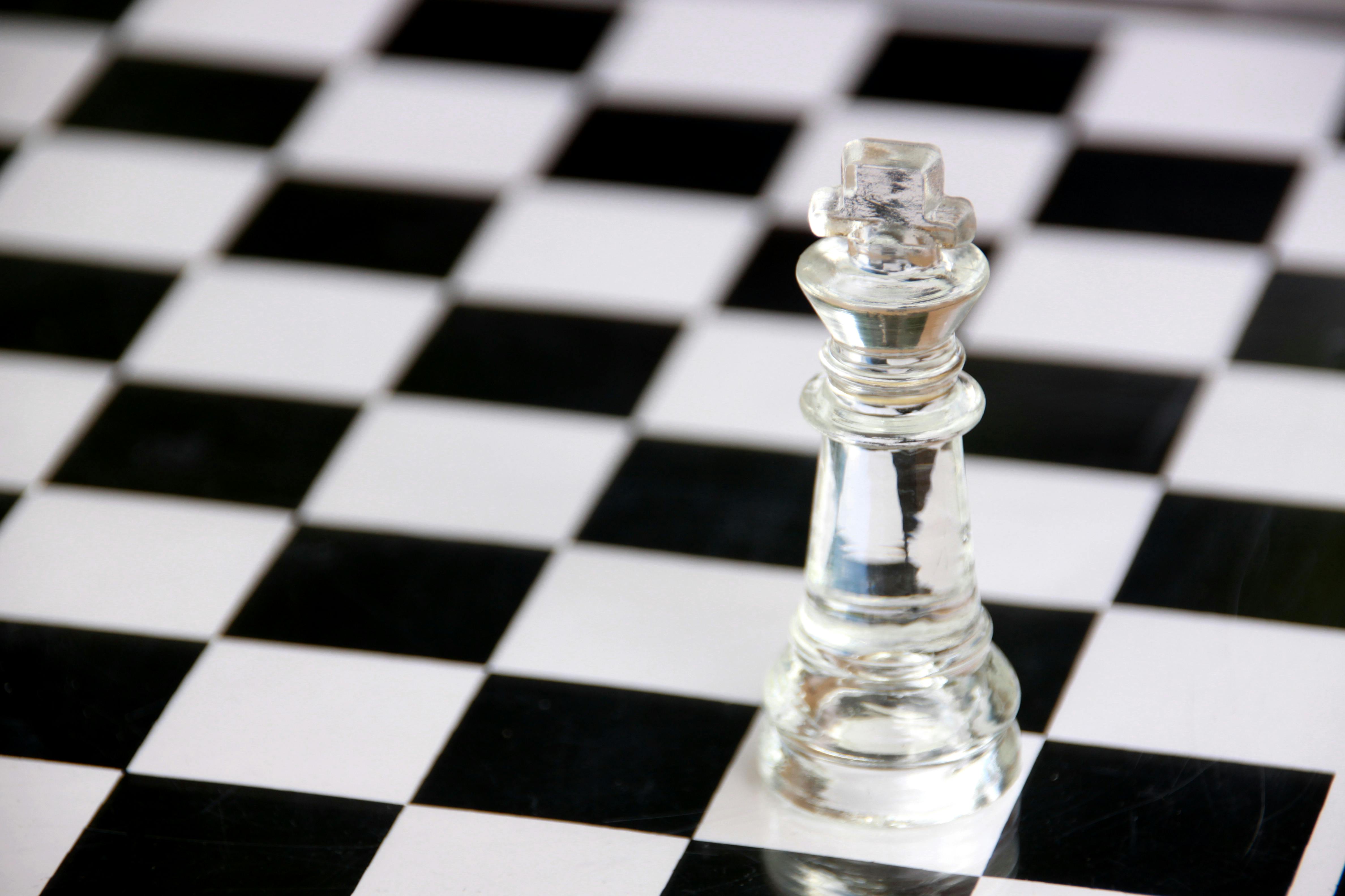 Chess Pieces Red Lined Up On A Dark Board Backgrounds