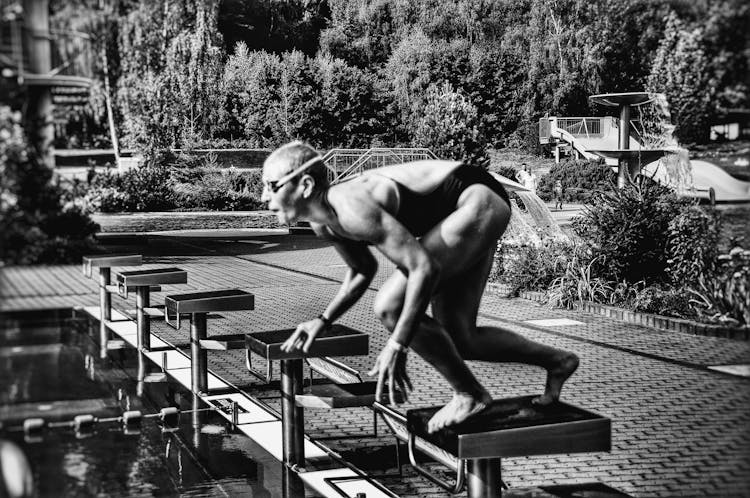 Swimmer On Block Before Diving Into Pool