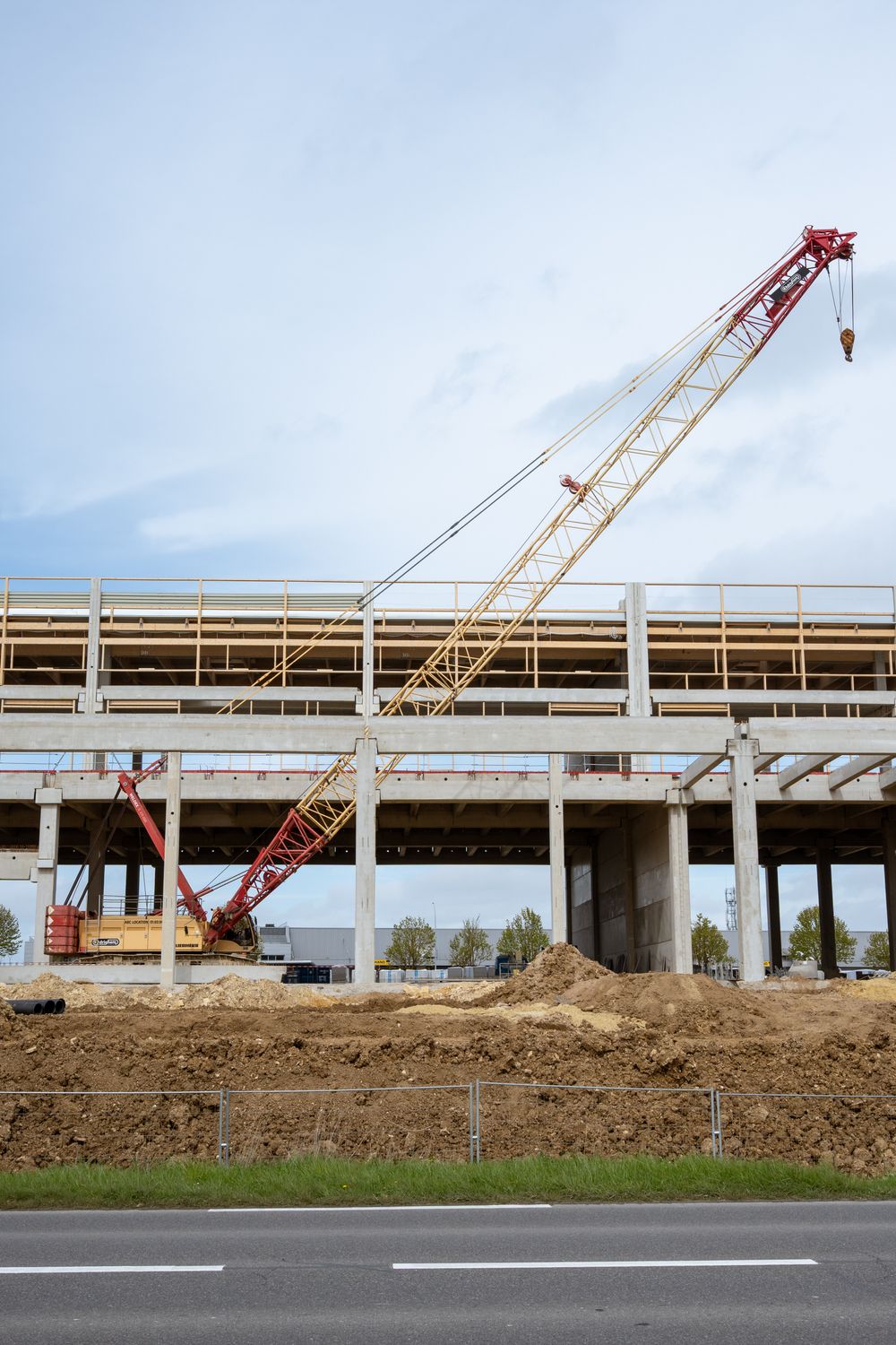 Crawler crane beside a concrete structure
